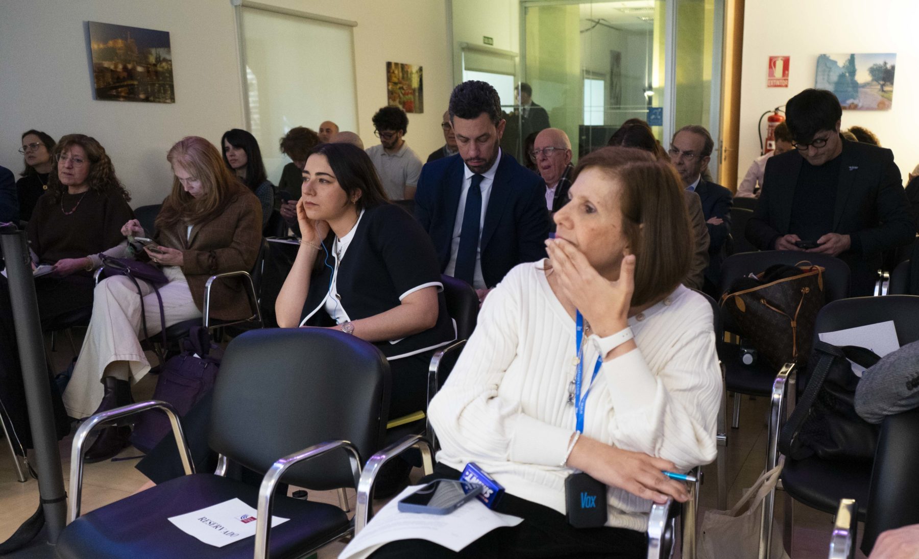 People seated in a small meeting room